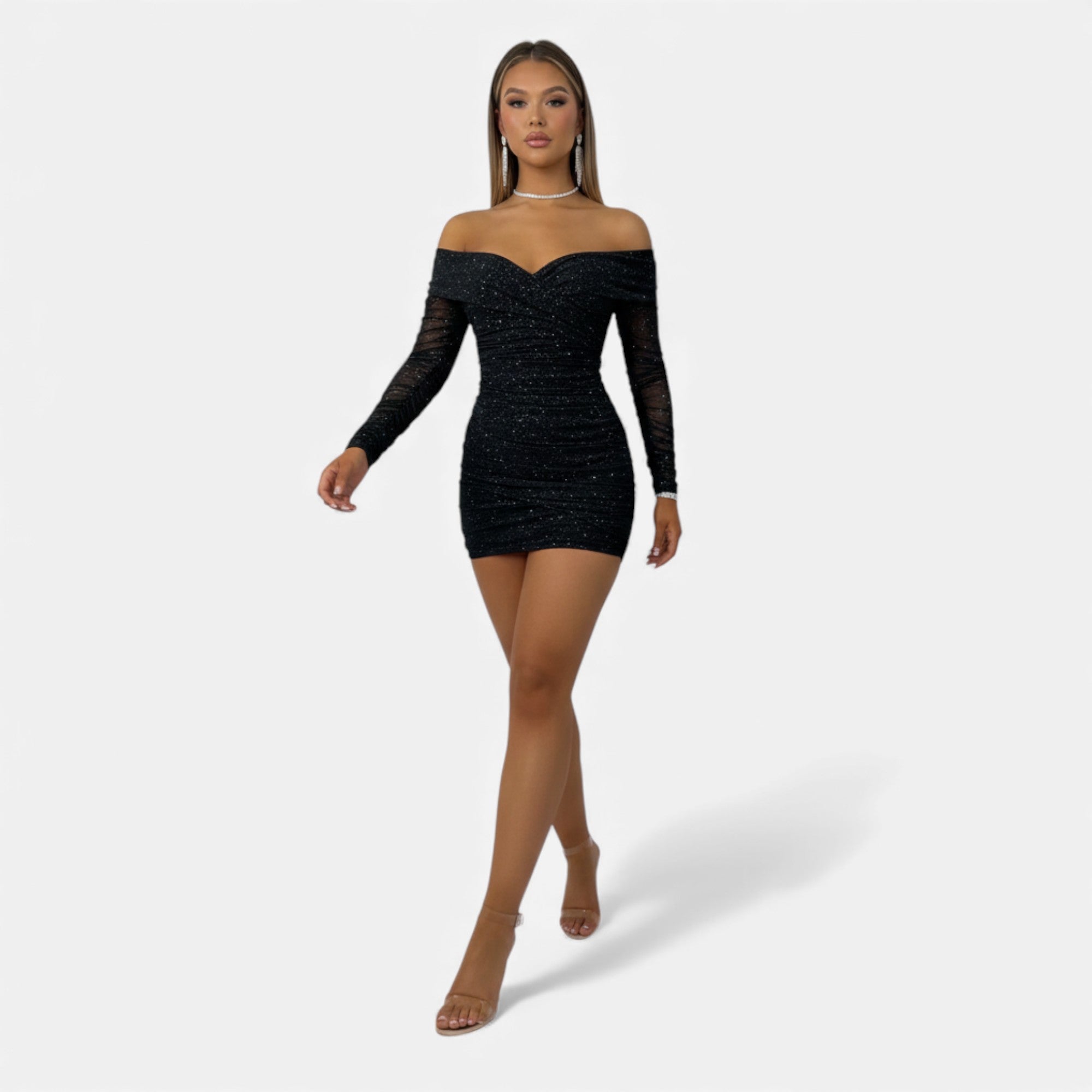 Black off-shoulder dress worn by a model on a white background